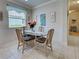 Dining room featuring a glass table with seating for four, complemented by coastal decor at 25784 Grayton Ave, Englewood, FL 34223