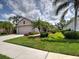 Beautifully landscaped home featuring a well-maintained lawn and charming curb appeal at 25784 Grayton Ave, Englewood, FL 34223