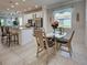 Bright kitchen features granite counters, stainless appliances, breakfast bar, and dining nook at 25784 Grayton Ave, Englewood, FL 34223