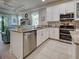Bright kitchen featuring stainless appliances, granite countertops, and an open layout at 25784 Grayton Ave, Englewood, FL 34223
