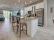 Bright kitchen with stainless steel appliances, breakfast bar, and stylish pendant lighting at 25784 Grayton Ave, Englewood, FL 34223