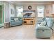 Cozy living room featuring comfortable seating, a large screen TV, and beach-themed decor at 25784 Grayton Ave, Englewood, FL 34223