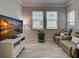 Cozy living room featuring wood-look flooring, neutral paint, and comfortable seating at 25784 Grayton Ave, Englewood, FL 34223
