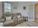 Comfortable living area with a reclining couch, natural lighting, and modern decor at 25784 Grayton Ave, Englewood, FL 34223