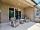 Inviting patio with comfortable seating and a sliding glass door to seamlessly blend indoor-outdoor living at 25784 Grayton Ave, Englewood, FL 34223