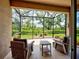 Relaxing screened patio with comfortable seating offers backyard views and fresh air at 25784 Grayton Ave, Englewood, FL 34223