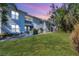 Low angle of a two-story condo with lawn, showing walkways and staircases at 2614 River Preserve Ct # 2614, Bradenton, FL 34208