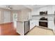 Bright kitchen featuring stainless steel appliances, granite countertops, and wooden floors at 2614 River Preserve Ct # 2614, Bradenton, FL 34208
