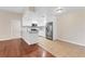 Modern kitchen featuring white cabinets, stainless steel appliances, and an eat-in island with granite countertops at 2614 River Preserve Ct # 2614, Bradenton, FL 34208