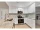 Bright kitchen with white cabinets, granite countertops, stainless steel appliances, and a modern backsplash at 2614 River Preserve Ct # 2614, Bradenton, FL 34208