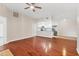 Open-concept living room with ceiling fan, hardwood floors, and view of the kitchen at 2614 River Preserve Ct # 2614, Bradenton, FL 34208
