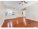 Spacious living room with hardwood floors, ceiling fan, and a view of the open kitchen at 2614 River Preserve Ct # 2614, Bradenton, FL 34208