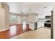 Open concept living room and kitchen featuring stainless appliances, hardwood floors, and lots of natural light at 2614 River Preserve Ct # 2614, Bradenton, FL 34208