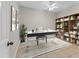 Bright and functional office space with a stylish desk, ample shelving, and a ceiling fan for added comfort at 2614 River Preserve Ct # 2614, Bradenton, FL 34208