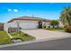 Inviting single-story home showcasing a well-manicured lawn, mature landscaping, and a welcoming entrance with ample driveway space at 270 Capri Ave, Venice, FL 34293