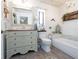 Charming bathroom with a vintage-style vanity, soaking tub, and decorative accents at 30 Jamestown Ave, Englewood, FL 34223
