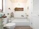 Bright bathroom featuring a soaking tub with white paneling and vintage decor at 30 Jamestown Ave, Englewood, FL 34223