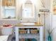 Charming bathroom featuring a white wicker mirror, wooden vanity with storage and beach-themed decor at 30 Jamestown Ave, Englewood, FL 34223