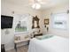 Comfortable bedroom with a large window, soft lighting, and a calming atmosphere at 30 Jamestown Ave, Englewood, FL 34223