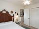 Inviting bedroom featuring a wood headboard, neutral walls, and access to adjacent rooms at 30 Jamestown Ave, Englewood, FL 34223
