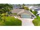 Charming single Gathering home with a well kept lawn, tidy landscaping, and an extra long driveway at 30 Jamestown Ave, Englewood, FL 34223