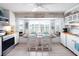 Well-lit kitchen features a window seat, white cabinetry, and stainless steel appliances at 30 Jamestown Ave, Englewood, FL 34223