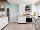 Well-lit kitchen with modern appliances, wood countertops, a pantry, and white cabinets at 30 Jamestown Ave, Englewood, FL 34223