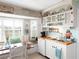 Cozy kitchen features white cabinets, wooden countertops, and a charming window nook at 30 Jamestown Ave, Englewood, FL 34223