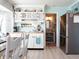 Bright kitchen with white cabinets, stainless steel appliances, and a charming vintage aesthetic at 30 Jamestown Ave, Englewood, FL 34223