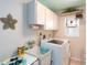 Functional laundry room with a utility sink, washer, dryer, and ample storage space at 30 Jamestown Ave, Englewood, FL 34223