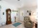 Comfortable room features a grandfather clock, soft chair, and ample natural light at 30 Jamestown Ave, Englewood, FL 34223