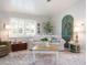 Cozy living room with a white sofa, shuttered windows, and charming decor at 30 Jamestown Ave, Englewood, FL 34223