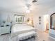 Cozy main bedroom with an ornate bed frame, neutral decor, and an ensuite bathroom at 30 Jamestown Ave, Englewood, FL 34223