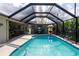 Screened pool and lanai featuring a bar, comfortable seating, and a beautiful view at 30 Jamestown Ave, Englewood, FL 34223