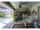Relaxing poolside lounge area with comfortable seating, potted plants, and a ceiling fan at 30 Jamestown Ave, Englewood, FL 34223