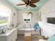 Cozy sunroom with neutral colors, a wicker ceiling fan, and lots of natural light at 30 Jamestown Ave, Englewood, FL 34223