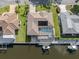 Aerial view of waterfront home, pool, hot tub, boat lift, dock, and canal at 314 Oakwood Cir, Englewood, FL 34223