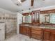 Spacious bathroom featuring a walk-in shower, dual sinks, granite countertops, and wood cabinetry at 314 Oakwood Cir, Englewood, FL 34223