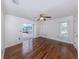 Bedroom with wood floors, windows, and a sliding glass door leading to an outdoor patio with a pool at 314 Oakwood Cir, Englewood, FL 34223