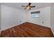 Bright bedroom featuring hardwood floors, a ceiling fan, and a window with natural light at 314 Oakwood Cir, Englewood, FL 34223