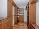 A large walk-in closet with built-in shelving and drawers at 314 Oakwood Cir, Englewood, FL 34223