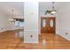 Bright foyer with gleaming wood floors and double front doors leading into the spacious interior at 314 Oakwood Cir, Englewood, FL 34223