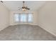 Open living room features ceramic tile flooring, a ceiling fan, and lots of natural light at 314 Oakwood Cir, Englewood, FL 34223