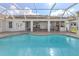 Beautiful in-ground pool with an enclosed patio area and ample space for outdoor seating at 314 Oakwood Cir, Englewood, FL 34223