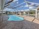In-ground pool with screened-in enclosure, and beautiful views of the canal and neighborhood at 314 Oakwood Cir, Englewood, FL 34223