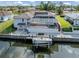This waterfront home has a screened-in pool and hot tub, tile roof, and a boat lift on the canal at 314 Oakwood Cir, Englewood, FL 34223