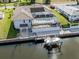 Waterfront home boasts screened pool, boat lift, manicured yard, and solar panels for sustainable living at 314 Oakwood Cir, Englewood, FL 34223