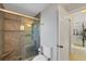 Bathroom featuring a tile shower with glass door and seat, plus white toilet at 316 Signorelli Dr, Nokomis, FL 34275