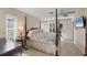Primary bedroom featuring a four-poster bed, dresser, and light from the windows at 316 Signorelli Dr, Nokomis, FL 34275