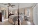 Spacious primary bedroom featuring a four-poster bed, dresser, and tile floors at 316 Signorelli Dr, Nokomis, FL 34275
